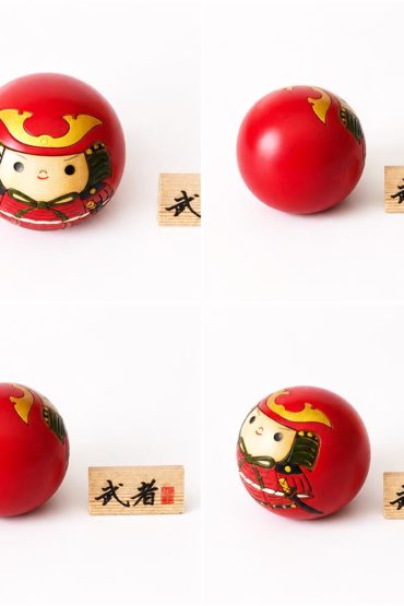 Musha round Japanese wooden kokeshi doll by Usaburo featuring a samurai in red armour with a wooden 武者 name plaque.
