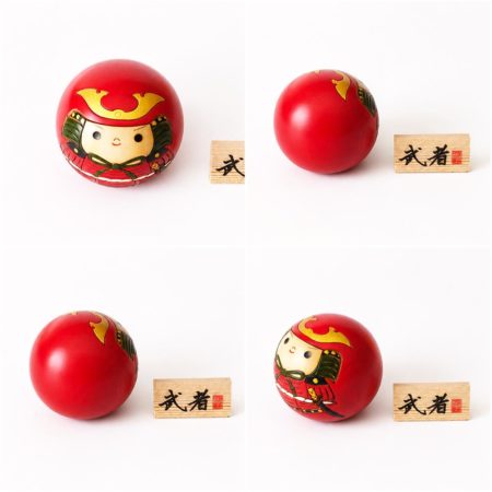 Musha round Japanese wooden kokeshi doll by Usaburo featuring a samurai in red armour with a wooden 武者 name plaque.