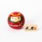 Musha round Japanese wooden kokeshi doll by Usaburo featuring a samurai in red armour with a wooden 武者 name plaque.
