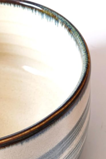 Harugasumi Japanese Mino ware matcha bowl with soft blue-grey glaze on white porcelain, made in Japan
