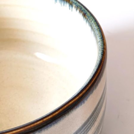 Harugasumi Japanese Mino ware matcha bowl with soft blue-grey glaze on white porcelain, made in Japan