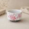 Japanese Sakura layered matcha bowl made in Japan with layered pink cherry blossom design, white Mino ware chawan and grey base