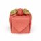 Japanese reversible cotton furoshiki tied around a gift, with a white dotted wave pattern on vermilion red and a green cherry blossom reverse visible at the knot.