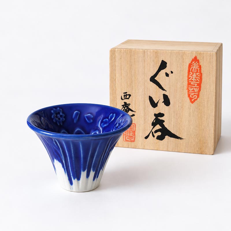 Mount Fuji Sake Cup – Blue Fuji | Porcelain in Wooden Gift Box Blue Mount Fuji porcelain sake cup with cherry blossom details inside, presented with a paulownia wooden gift box.. Available at j-okini Malta